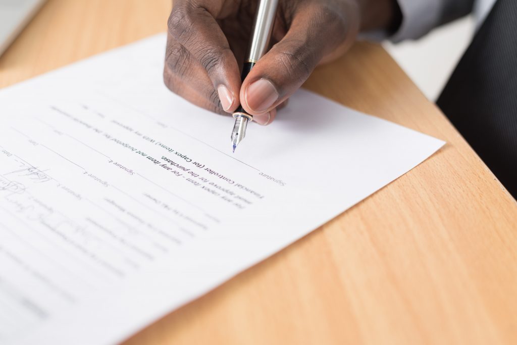 businessman filling out a tax form for year-end