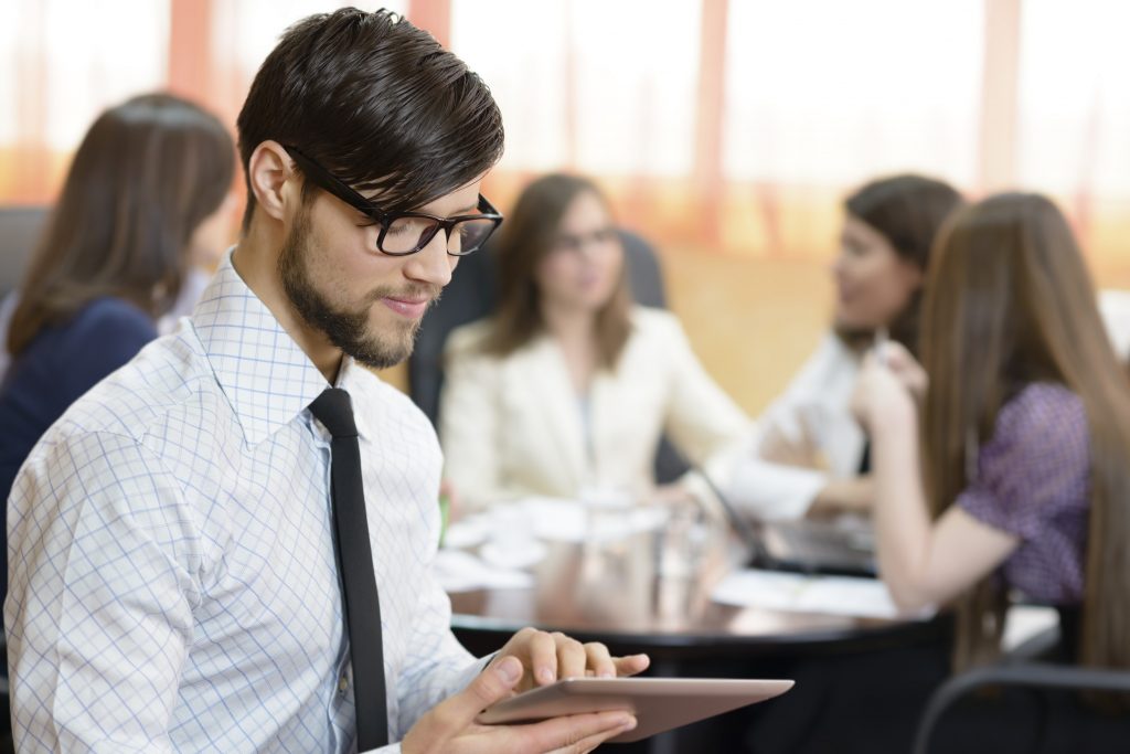 Successful businessman at the office leading a group